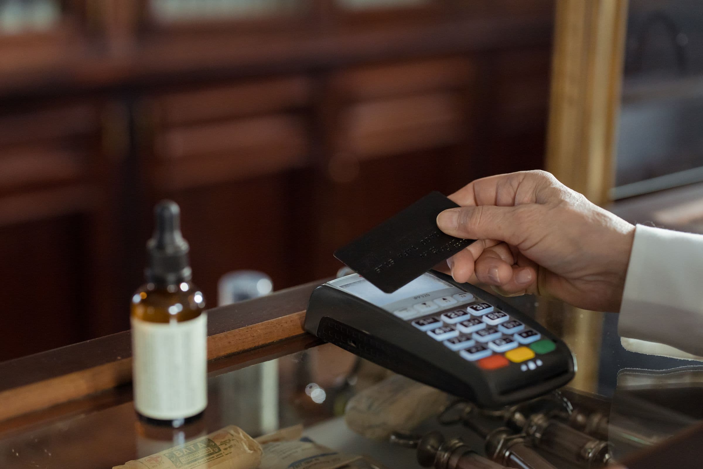 A person paying by card at a checkout.