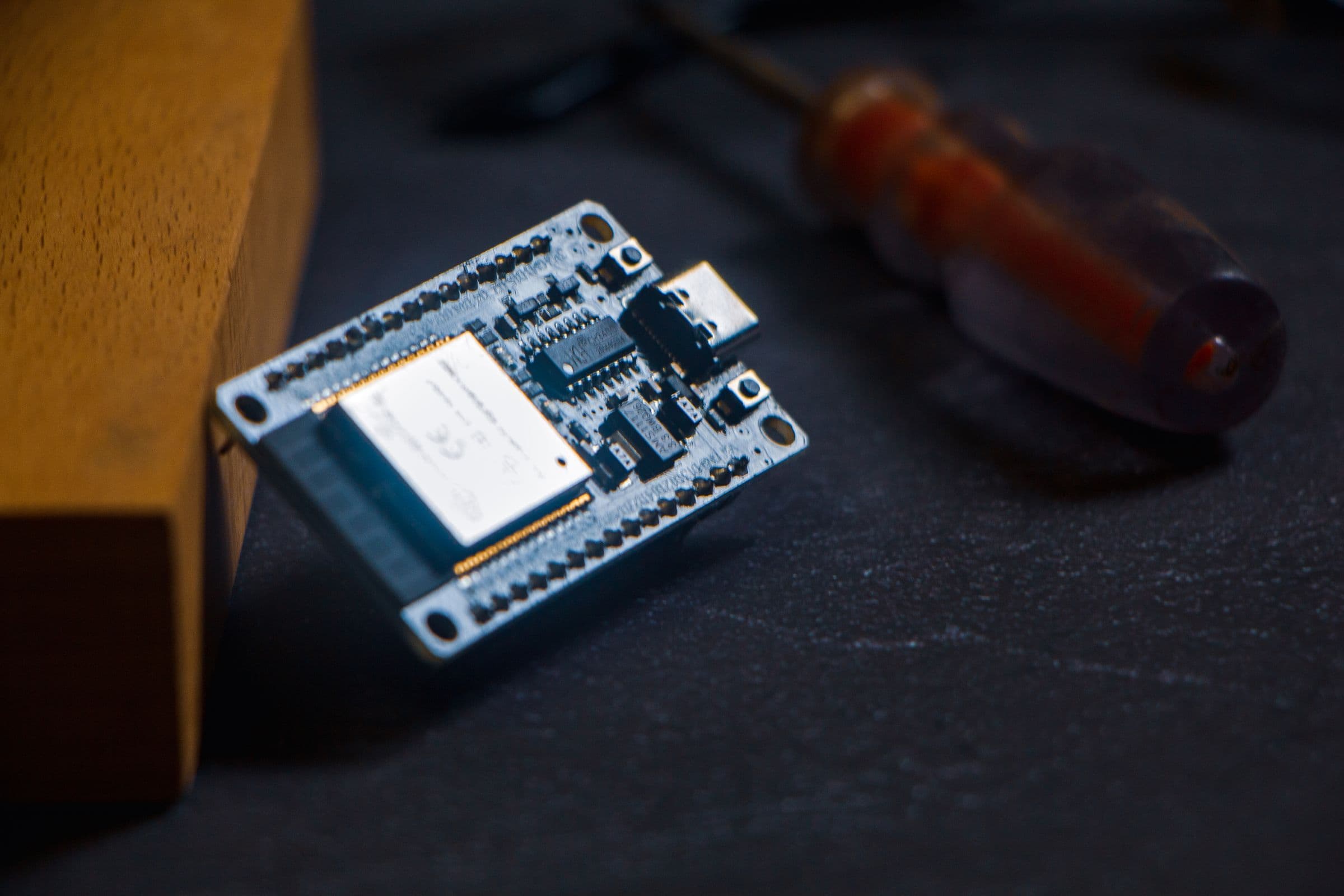 A microcontroller and tools on a work surface.