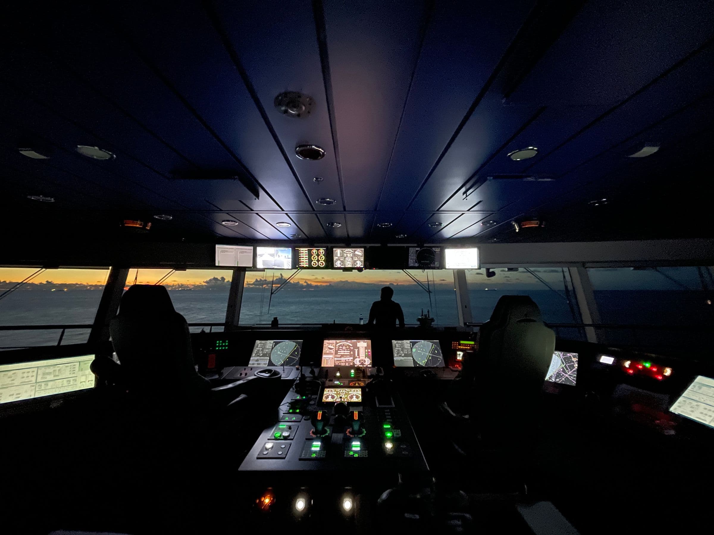 Operators inside a ship's control room.