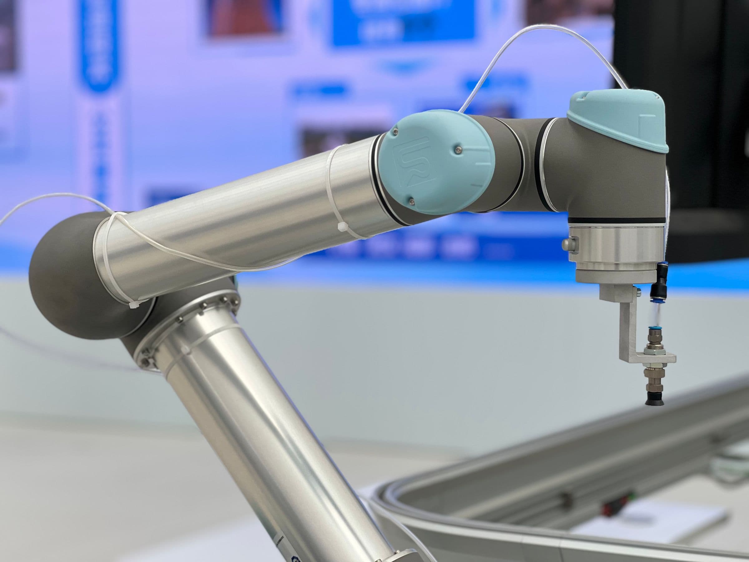 A close-up of an industrial robotic arm and its tool.