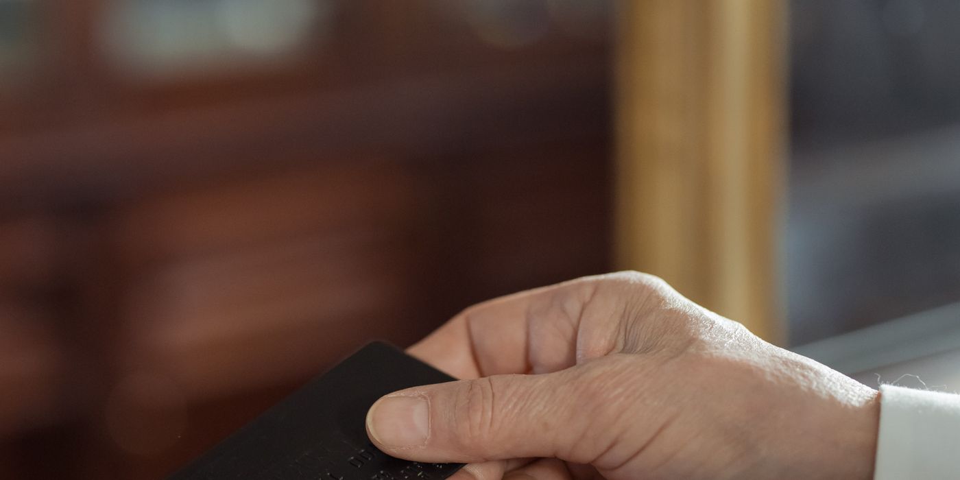 A hand holding a black card.