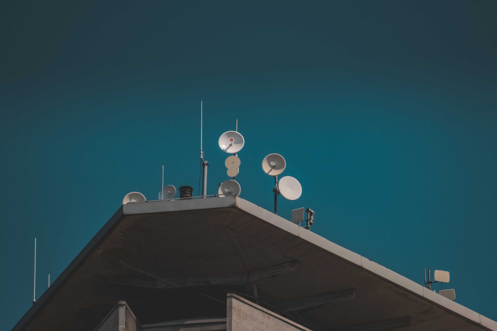 Satellite dishes on a rooftop.