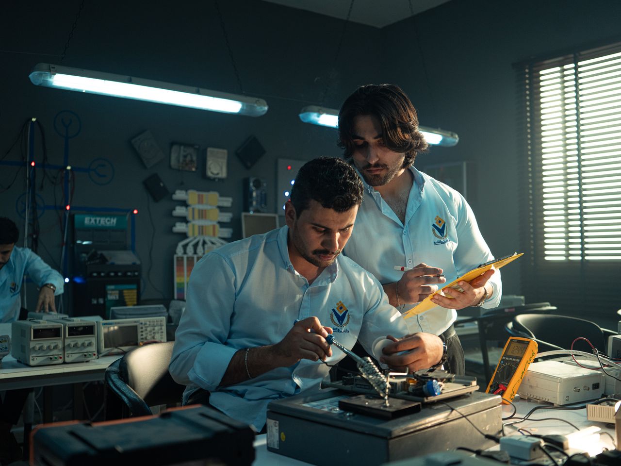 Engineers working in an electronics laboratory.
