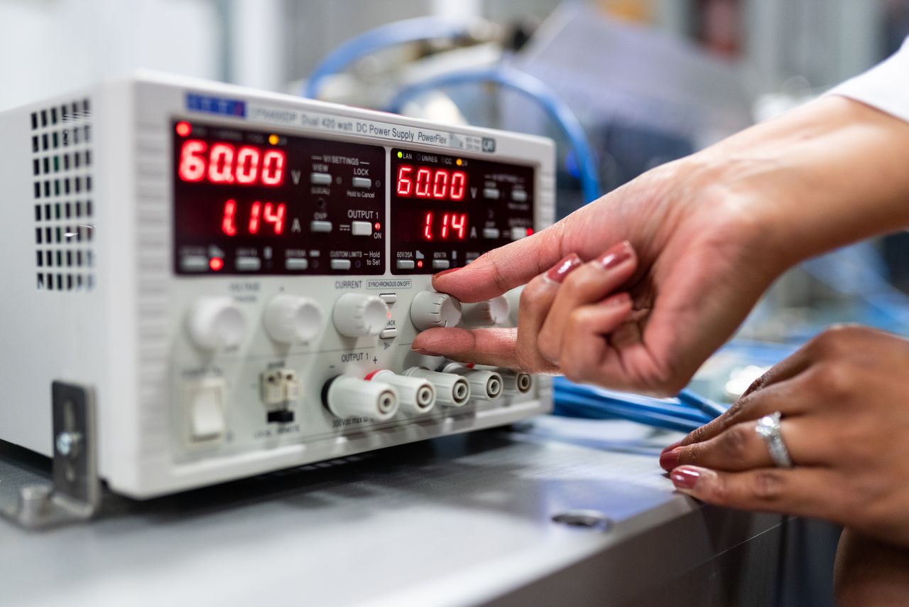 An engineer adjusting laboratory equipment.