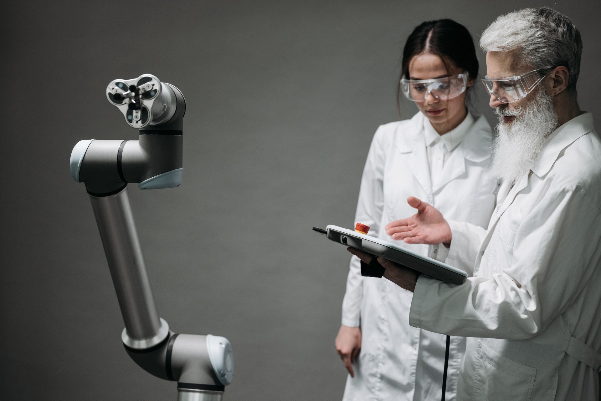An engineer working with a robotic arm.