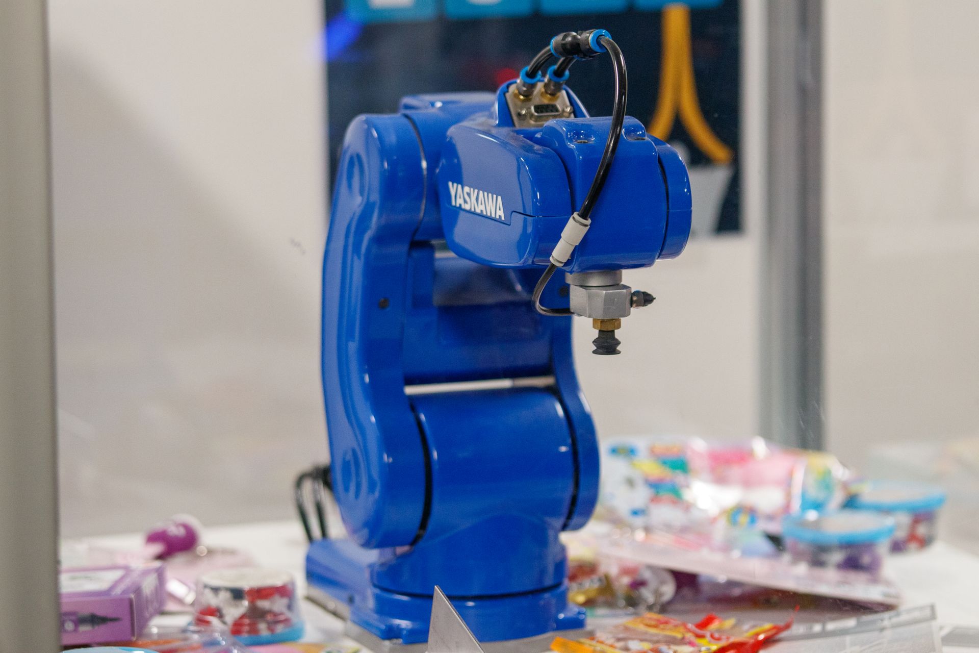 An industrial robot arm inside a manufacturing cell.